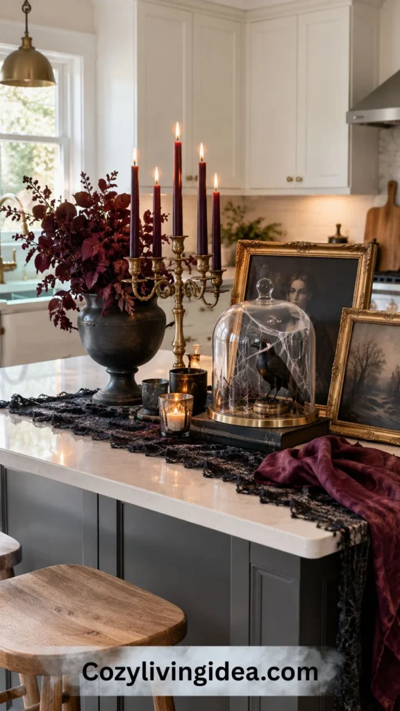 Gothic Halloween kitchen island with candelabra, plum accents, gilded portrait frames and a raven under a cobwebbed glass cloche